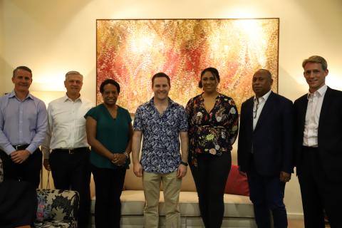 Group photo infront of a colourful pacific islander artwork piece with the Minister for International Development and the Pacific, the Hon Alex Hawke MP and representatives from the business community